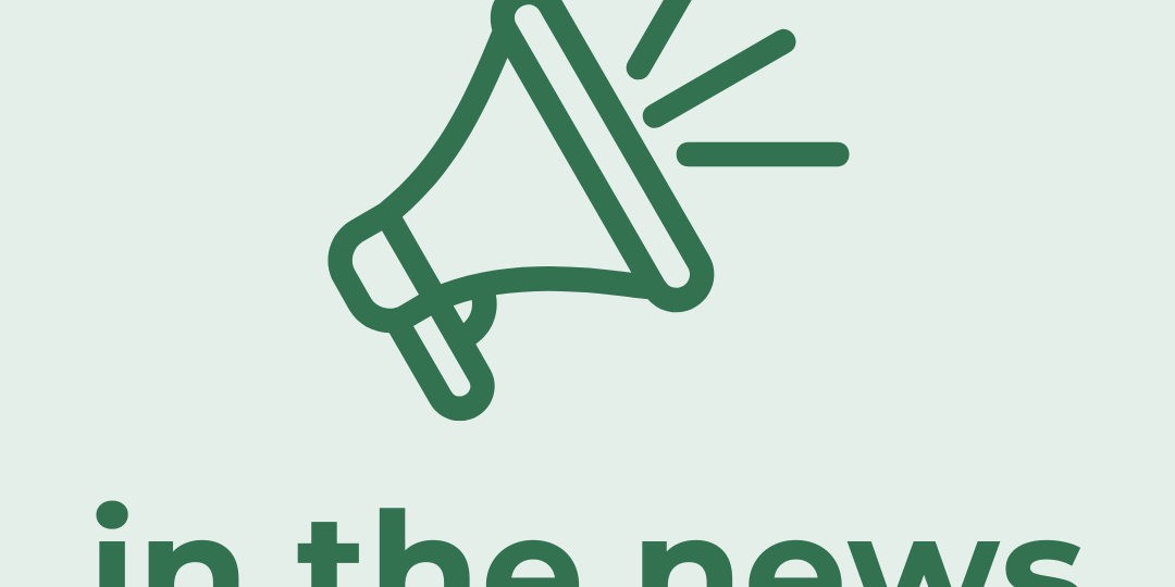 green bullhorn on tan background with "in the news" text
